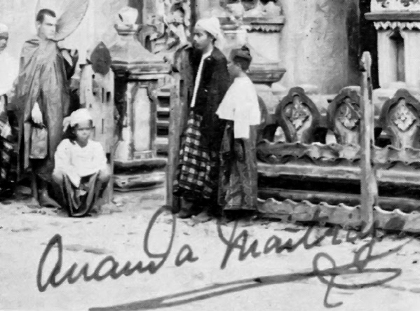 Vintage photograph of people in traditional clothing before ornate stone temple, signed Ananda Metteyya.