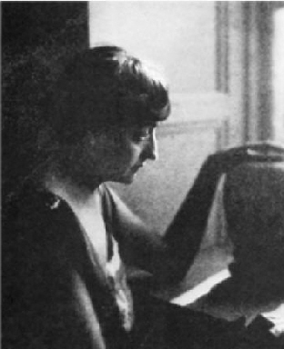 Black-and-white vintage photograph of a woman in profile, looking down, hand on large vase