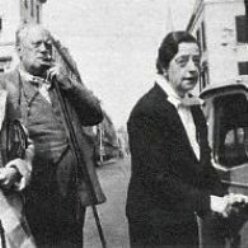 Vintage black and white photo showing a man and woman on street