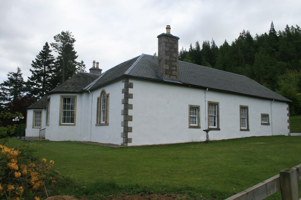 Rear and side view of Boleskine House with stone chimneys, slate roof, windows